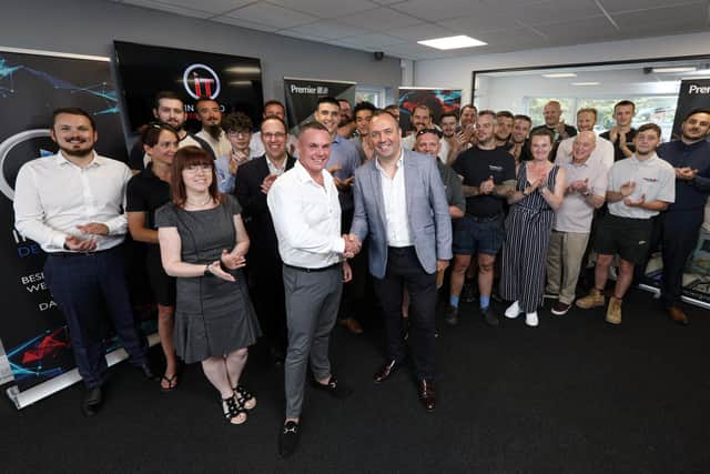 Interpro CEO Mark Abrams, centre, in jacket, CEO Premier Group Adrian Donald, in white shirt, and staff celebrate the office move. Interpro have moved into new offices in Fareham Heights, Wallington, Fareham. The work has been done by Premier Group
Picture: Chris Moorhouse (jpns 230721-01)
