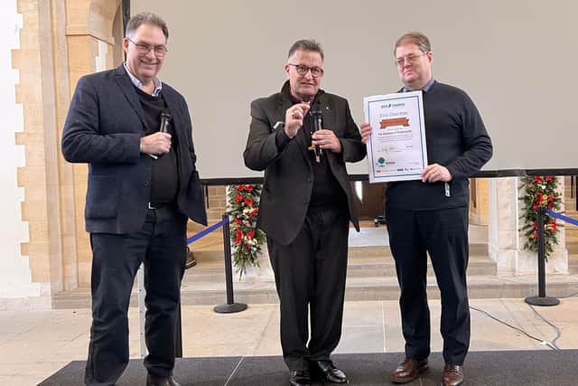 Andy Atkins, CEO of environmental charity A Rocha, awards a Bronze Eco-Diocese Award to Bishop Jonathan Frost and environmental officer David Cain from Portsmouth diocese, to celebrate its achievements so far