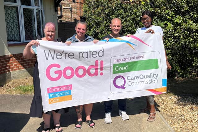 Members of The Mullion care team celebrating their achievement with a ‘Good’ CQC result banner.
