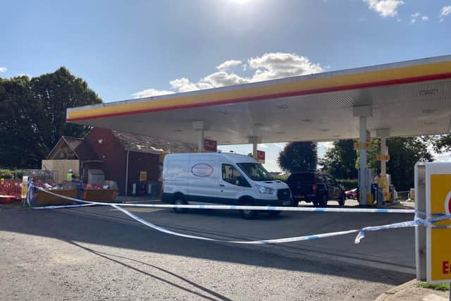 Workers repairing the Shell garage in Wickham after a car ploughed into it last night.