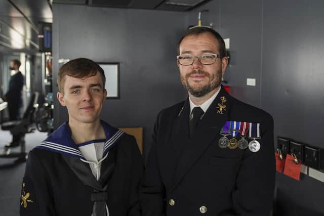 Members of the crew, Morgan (left) and his father, Paul Brookes,  after Queen Elizabeth II visited HMS Queen Elizabeth at HM Naval Base, Portsmouth, ahead of the ship's maiden deployment. The visit comes as HMS Queen Elizabeth prepares to lead the UK Carrier Strike Group on a 28-week operational deployment travelling over 26,000 nautical miles from the Mediterranean to the Philippine Sea. Picture: Steve Parsons/PA Wire