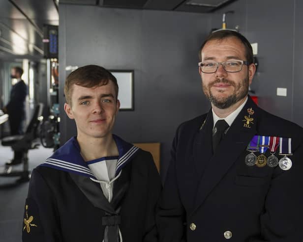 Members of the crew, Morgan (left) and his father, Paul Brookes,  after Queen Elizabeth II visited HMS Queen Elizabeth at HM Naval Base, Portsmouth, ahead of the ship's maiden deployment. The visit comes as HMS Queen Elizabeth prepares to lead the UK Carrier Strike Group on a 28-week operational deployment travelling over 26,000 nautical miles from the Mediterranean to the Philippine Sea. Picture: Steve Parsons/PA Wire