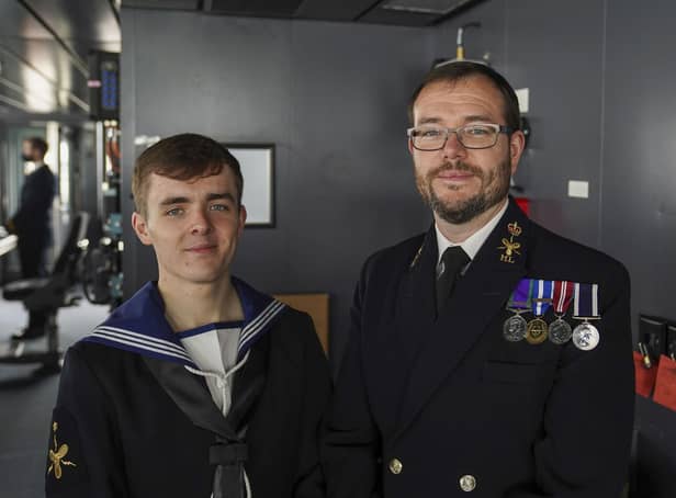 Members of the crew, Morgan (left) and his father, Paul Brookes,  after Queen Elizabeth II visited HMS Queen Elizabeth at HM Naval Base, Portsmouth, ahead of the ship's maiden deployment. The visit comes as HMS Queen Elizabeth prepares to lead the UK Carrier Strike Group on a 28-week operational deployment travelling over 26,000 nautical miles from the Mediterranean to the Philippine Sea. Picture: Steve Parsons/PA Wire