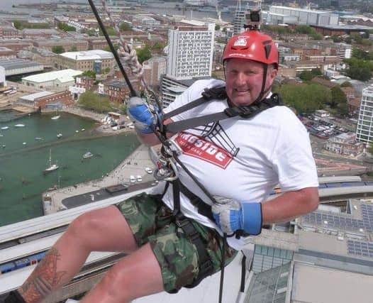 Larry Richards as he abseils down the tower. 
