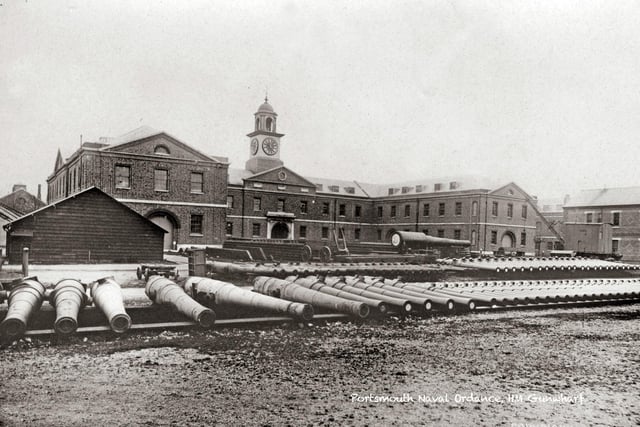 Inside Gunwharf, years before it became a residential site. The building to the rear still stands as apartments and a studio. The massive guns and implements to the rear show what the location was used for before becoming HMS Vernon.