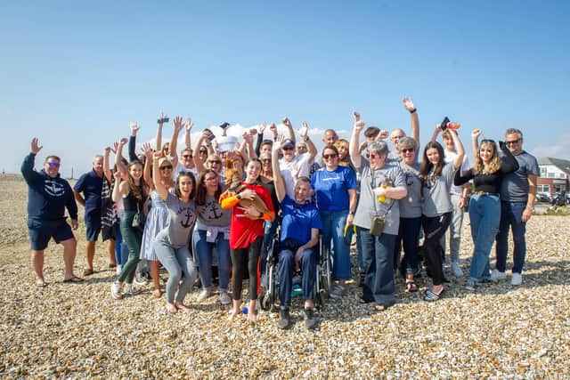 12-year-old Seren Killpartrick from Fareham is paddleboarding from the Isle of Wight to Stokes Bay to raise money for brain tumour treatment for her dad.Pictured: Seren Killpartrick with friends and family at Stokes Bay beach on Thursday 16th September 2021Picture: Habibur Rahman