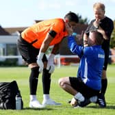 Denmead keeper Chris Clark, left, prior to leaving the pitch during the game against his former club Hayling United. Picture: Chris Moorhouse