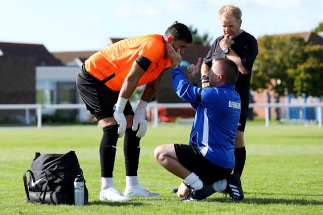 Denmead keeper Chris Clark, left, prior to leaving the pitch during the game against his former club Hayling United. Picture: Chris Moorhouse