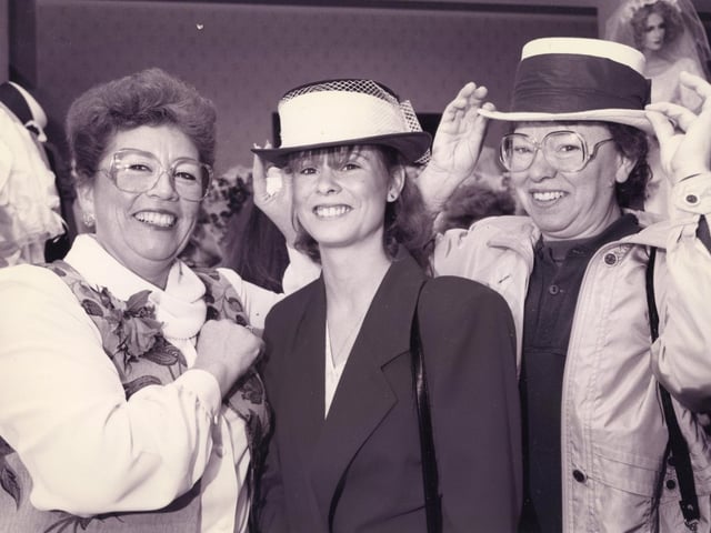 Maureen Vaughan of Bridal Dreams (left) assisting Jacqueline Hallett (23) and her mum Teresa Hellett (45) with a hat for their big day during their visit to The News' Fareham wedding show at the Solent Hotel, Whiteley. In 1995. The News PP1947