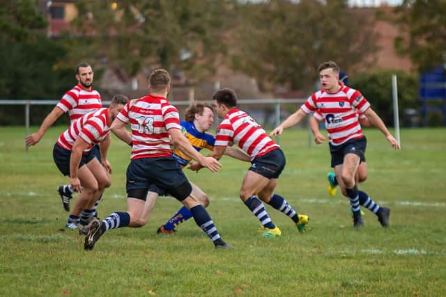 A sea of Havant shirts descends on Gosport & Fareham's Ben Smith. Picture: Mike Cooter
