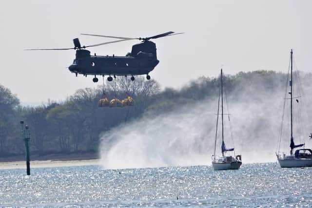 The RAF Chinook dropping off aggregate at Pewit Island, Portsmouth. Picture: Paul Morgan