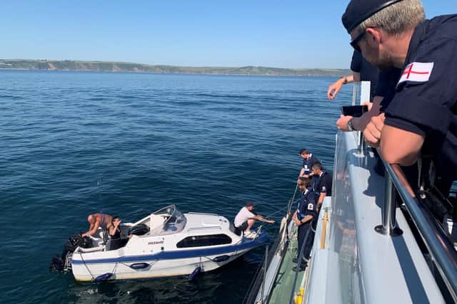 Fishermen are helped by sailors from HMS Puncher. Photo: Royal Navy