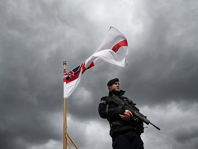 Crew member AB Tobias Fairall patrols the flight deck of HMS Illustrious May 10, 2013. Photo by Dan Kitwood/Getty Images