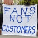 A Chelsea fan displays a banner protesting against the proposed European Super League prior to tonight's Premier League match between Chelsea and Brighton & Hove Albion at Stamford Bridge. Photo by Mike Hewitt/Getty Images.