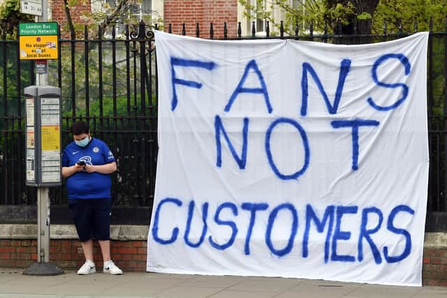 A Chelsea fan displays a banner protesting against the proposed European Super League prior to tonight's Premier League match between Chelsea and Brighton & Hove Albion at Stamford Bridge. Photo by Mike Hewitt/Getty Images.