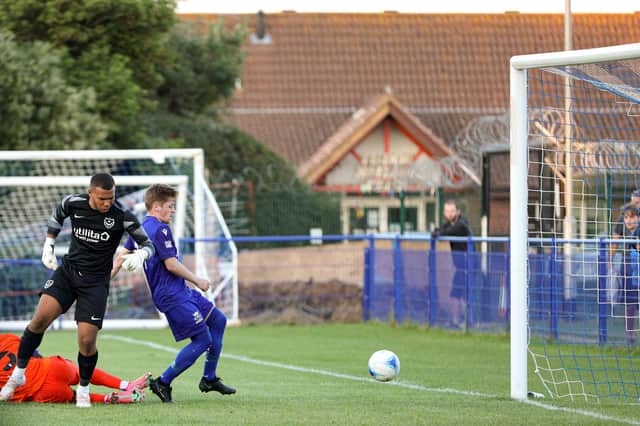 Callum Dart (blue) watches on as a Pompey XI player scores an own goal. Picture: Chris Moorhouse