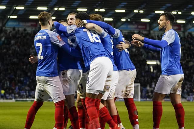 The Pompey players celebrate with Coby Bishop following his second goal in the Blues' 3-2 FA Cup second-round win against MK Dons