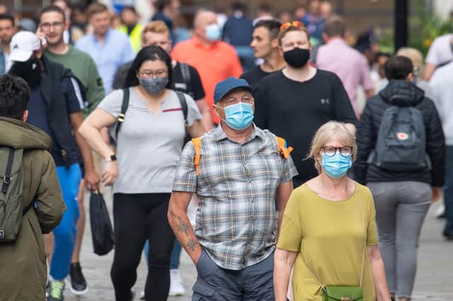 People wearing face masks among crowds of pedestrians in Covent Garden, London.  during the easing of lockdown restrictions in England. Picture date: Sunday July 4, 2021. PA Photo. Rumours were abound in the Sunday newspapers that Prime Minister Boris Johnson, who is due to update the nation this week on plans for unlocking, is due to scrap social distancing and mask-wearing requirements on so-called "Freedom Day". See PA story HEALTH Coronavirus. Photo credit should read: Dominic Lipinski/PA Wire