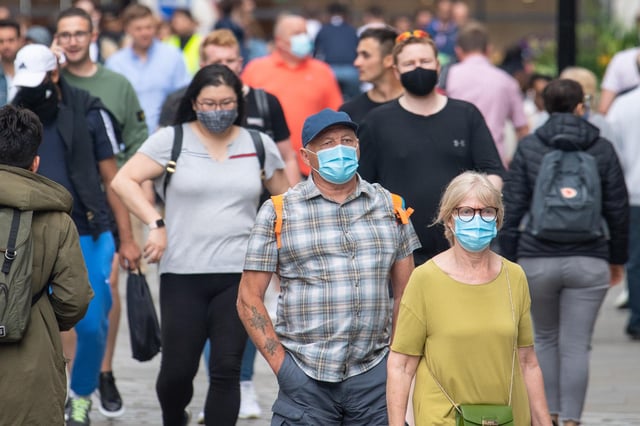 People wearing face masks among crowds of pedestrians in Covent Garden, London. during the easing of lockdown restrictions in England. Picture date: Sunday July 4, 2021. PA Photo. Rumours were abound in the Sunday newspapers that Prime Minister Boris Johnson, who is due to update the nation this week on plans for unlocking, is due to scrap social distancing and mask-wearing requirements on so-called "Freedom Day". See PA story HEALTH Coronavirus. Photo credit should read: Dominic Lipinski/PA Wire