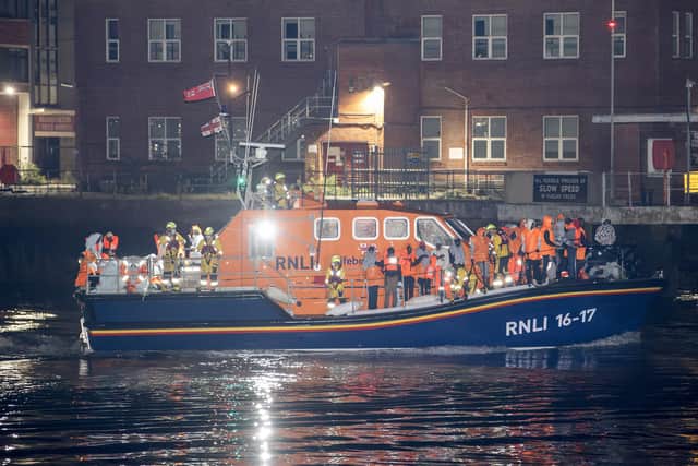 Over 100 migrants aboard two RNLI lifeboats entered Portsmouth Harbour on Sunday evening just after 10pm, heading for Fort Blockhouse in Gosport where teams from the Home Office were there to welcome the migrants. They were then heading to board one of a number of buses waiting for them. Credit: pictureexclusive.com