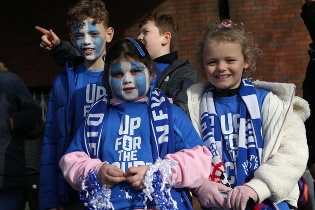 Young Pools' supporters sport face paints ahead of the match.