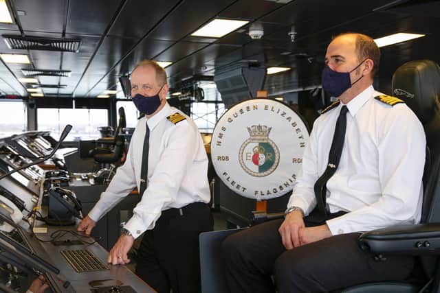 Fleet Commander, Vice Admiral Jerry Kyd RN on the left with the Commanding Officer of HMS Queen Elizabeth, Captain Angus Essenhigh RN on the right, on the bridge. 

HMS Queen Elizabeth today assumed the role of Fleet Flagship.