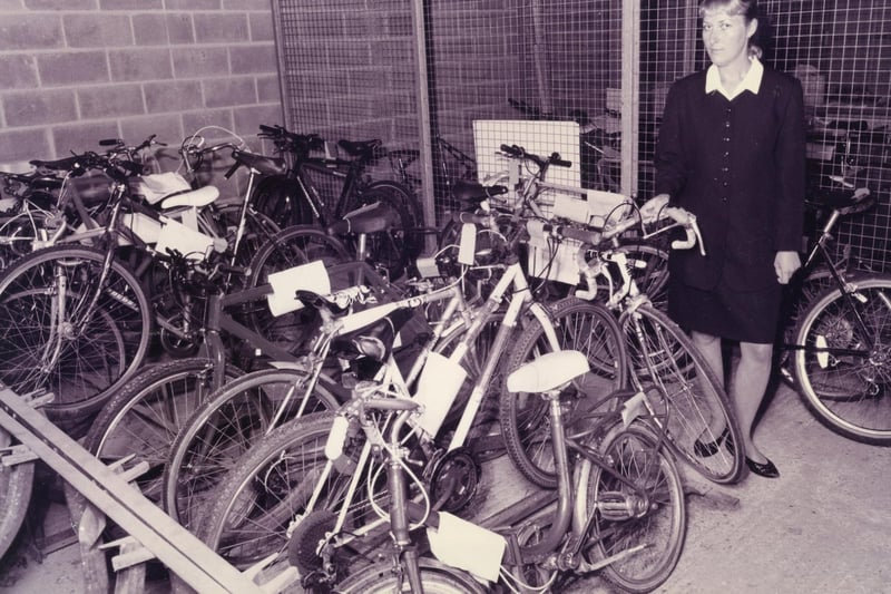 WPC Clare Harley of Fareham police station, with some of the many unclaimed bikes at the station, after a raise in bike crime in the area, October 1995. The News PP5528