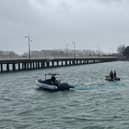 Harbour Teams deploy oil spill management equipment.