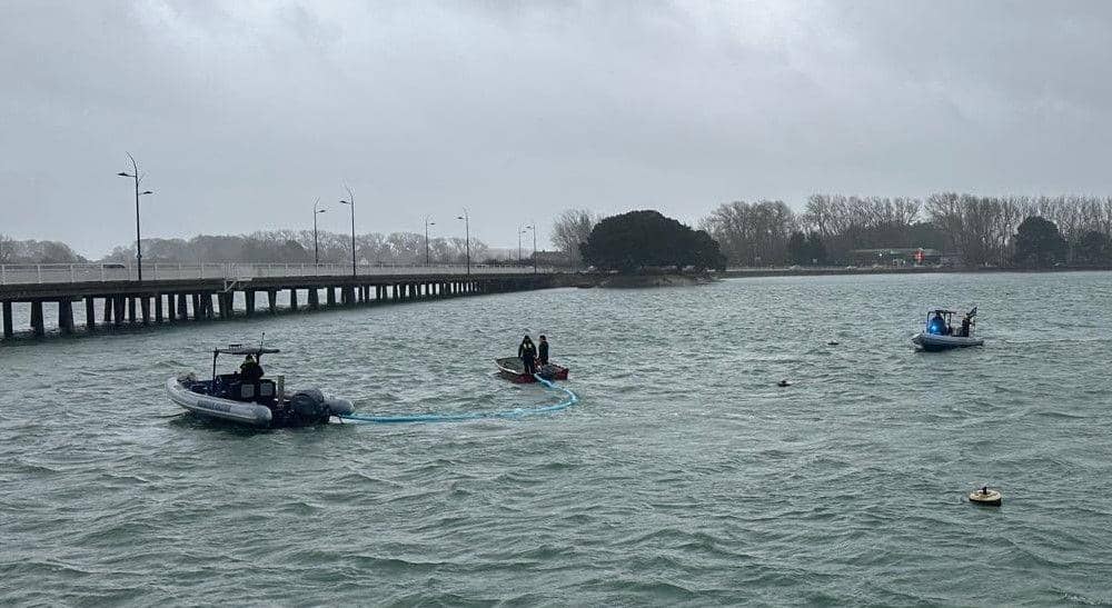 Harbour Teams deploy oil spill management equipment.