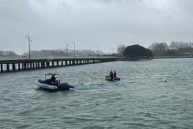 Harbour Teams deploy oil spill management equipment.