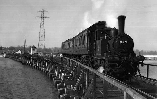 The Hayling Billy in her prime crossing Langstone trestle bridge.