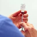 A vial of the Moderna Covid-19 vaccine being prepared. Photo by Steve Parsons / POOL / AFP via Getty Images