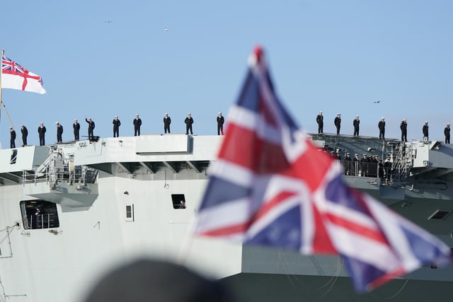 Sailors line the flight deck of the Royal Navy aircraft carrier HMS Prince of Wales as it returns to Portsmouth Naval Base following a three-month deployment to the Eastern Seaboard of the United States, where the Prince of Wales has been undergoing trials and operating with aircraft and drones. Picture: Andrew Matthews/PA Wire