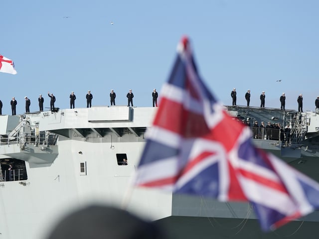 Sailors line the flight deck of the Royal Navy aircraft carrier HMS Prince of Wales as it returns to Portsmouth Naval Base following a three-month deployment to the Eastern Seaboard of the United States, where the Prince of Wales has been undergoing trials and operating with aircraft and drones. Picture: Andrew Matthews/PA Wire