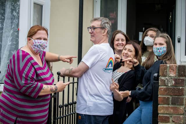 Pictured: Pete's daughter Vicky Callaway, Pete, his wife Linda, daughter Daisy Callaway and granddaughters, Creys Palmer and Phoebe Callaway. All are pointing to a "We Love QA" sign on his t-shirt.
Picture: Habibur Rahman