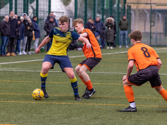 Action from the 2-2 draw between the under-18s of Moneyfields (blue/yellow kit) and AFC Portchester (orange/black kit). Picture: Mike Cooter