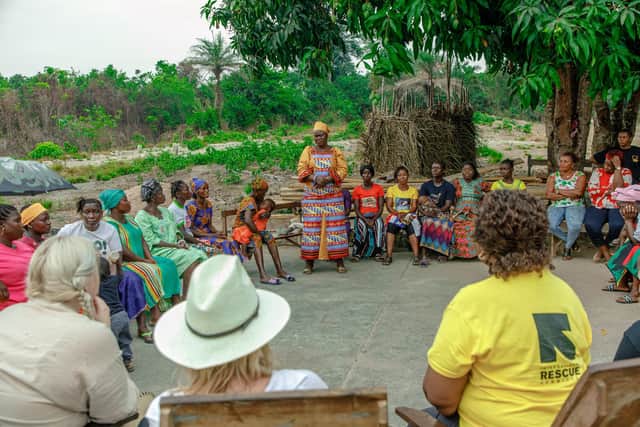 Caroline Dinenage (back to camera, wearing hat) on her visit to the Gbaiima Songa Health Centre
