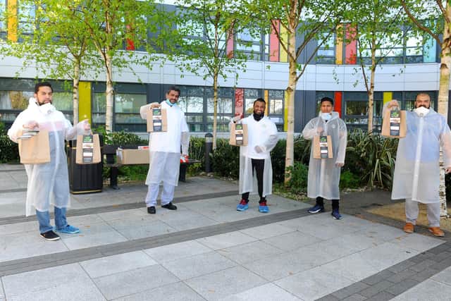 Members of the Bengali business community in Portsmouth have donated more than 100 hot meals to NHS staff at Queen Alexandra hospital. Staff from Wild Mango in Copnor and Shake & Grill in Southsea, delivered meals to QA on Monday, April 20.Pictured is: (l-r) Mohammad Alom, Kalidur Rahman, Mosu Miah, Muhammed Alom and Habibur Rahman from Wild Mango and Shake & Grill.Picture: Sarah Standing (200420-7879) 