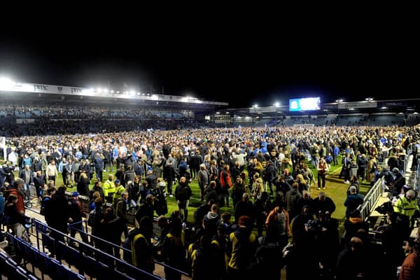 The pitch invasion after Pompey were crowned League One champions. Picture: Sarah Standing.