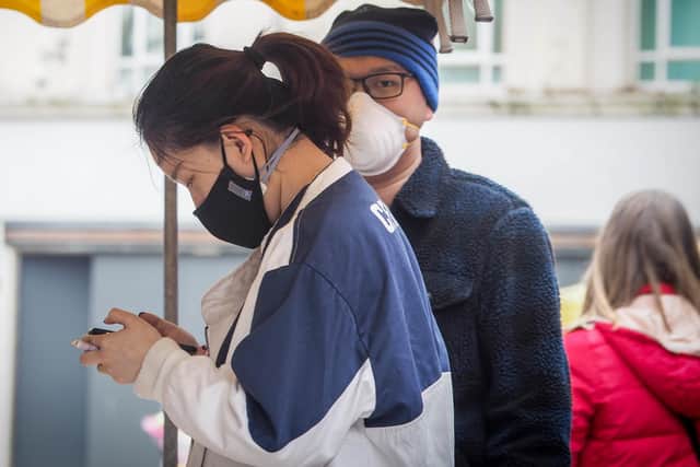 People wearing masks in Commercial Road on March 20. Picture: Habibur Rahman