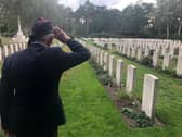 WW2 Veteran Den Hosgood saluting the fallen at a CWG Cemetery