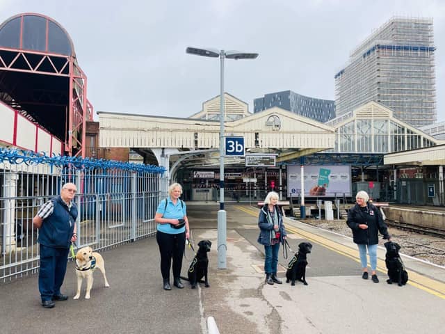 Puppy raisers Joe, Tina, Sue and Jacki with their puppies at the station