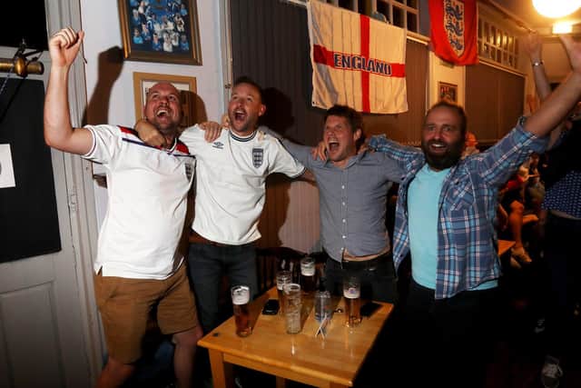 England fans at the Artillery Arms in Portsmouth last night. Similar scenes of joy were repeated in pubs and clubs up and down the country as England reached the Euro 2020 final. Picture: Sam Stephenson
