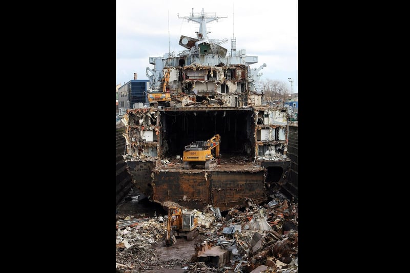 Giant demolition machines eat away at the hulk of the Falklands veteran ship HMS Intrepid as it sits in a dry dock while it is scrapped on March 4, 2009 in Liverpool. (Photo by Christopher Furlong/Getty Images)