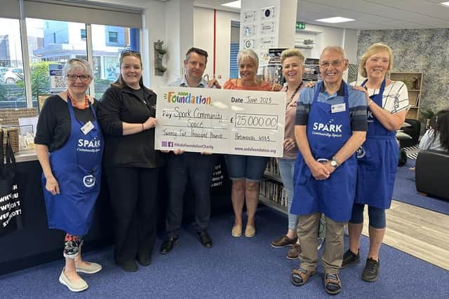 Spark Community Space receive a giant cheque foe £25,000 from The Asda Foundation