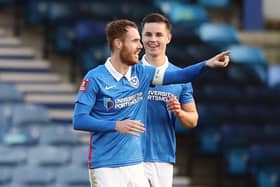 Tom Naylor points at colleague and house-mate Andy Cannon after scoring against King's Lynn on Saturday. Picture: Naomi Baker/Getty Images
