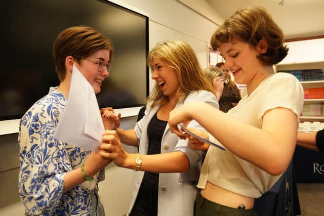 Students congratulate each other receiving their GCSE results. Photo: PA