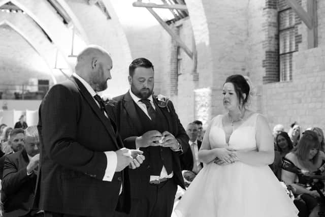 Leah and Aidan Longman during their wedding ceremony at The Tithe Barn, Petersfield. Picture: Carla Mortimer Photography