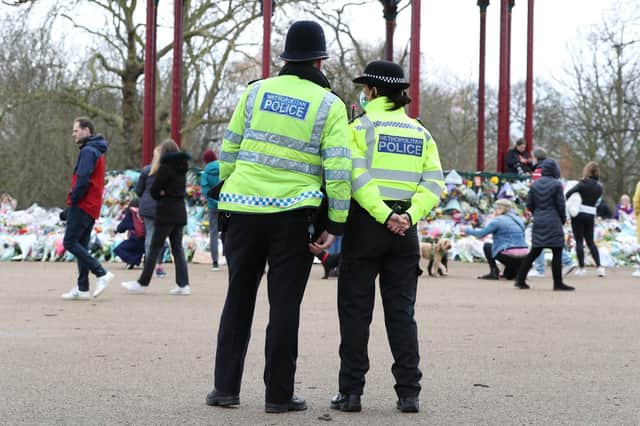 Police patrol near to floral tributes left at the bandstand in Clapham Common, London, for murdered Sarah Everard. Picture date: Tuesday March 16, 2021. Picture: Jonathan Brady/PA Wire