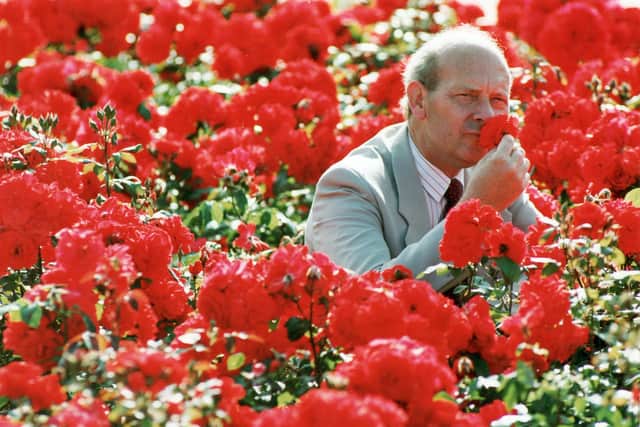Brian Kidd smelling some stunning roses.